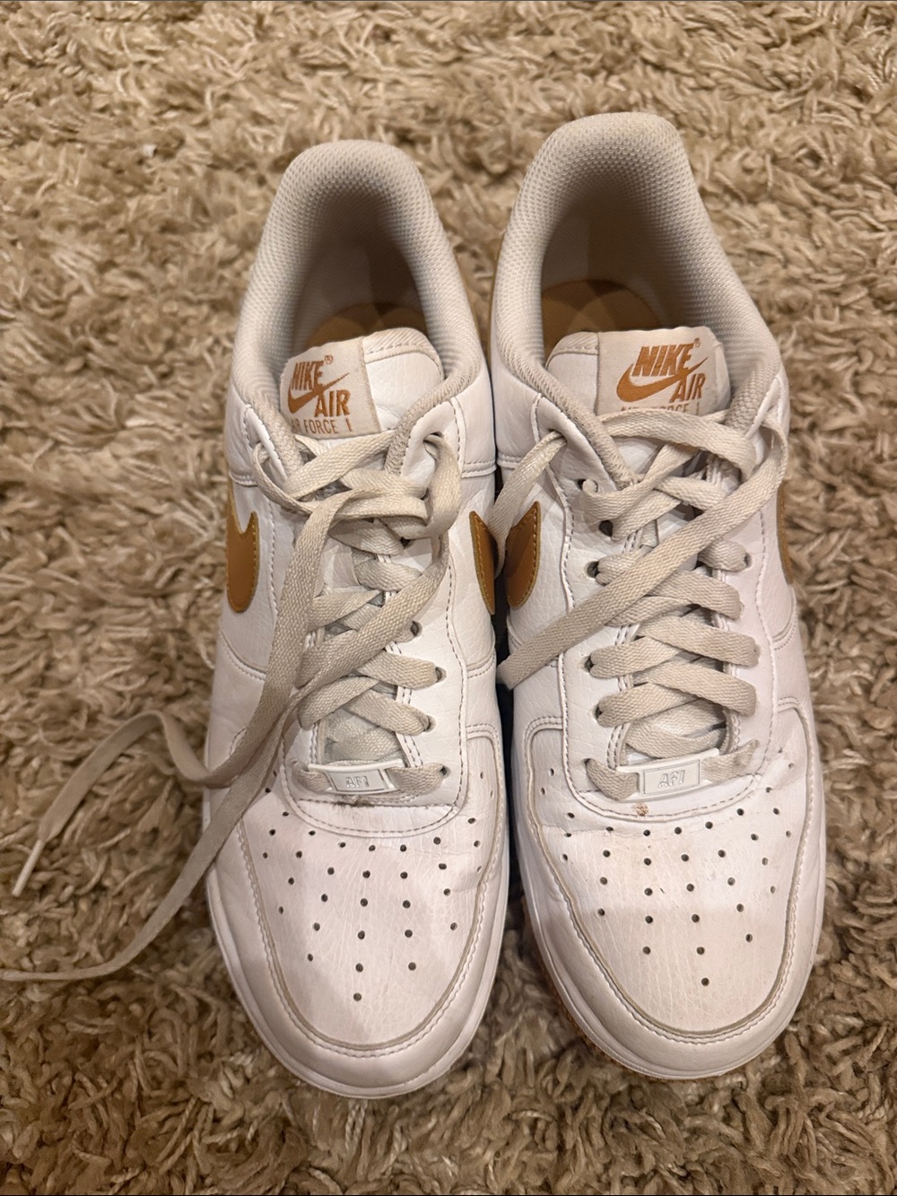 Nike White Sneakers with Gold Swoosh and Tongue Logo